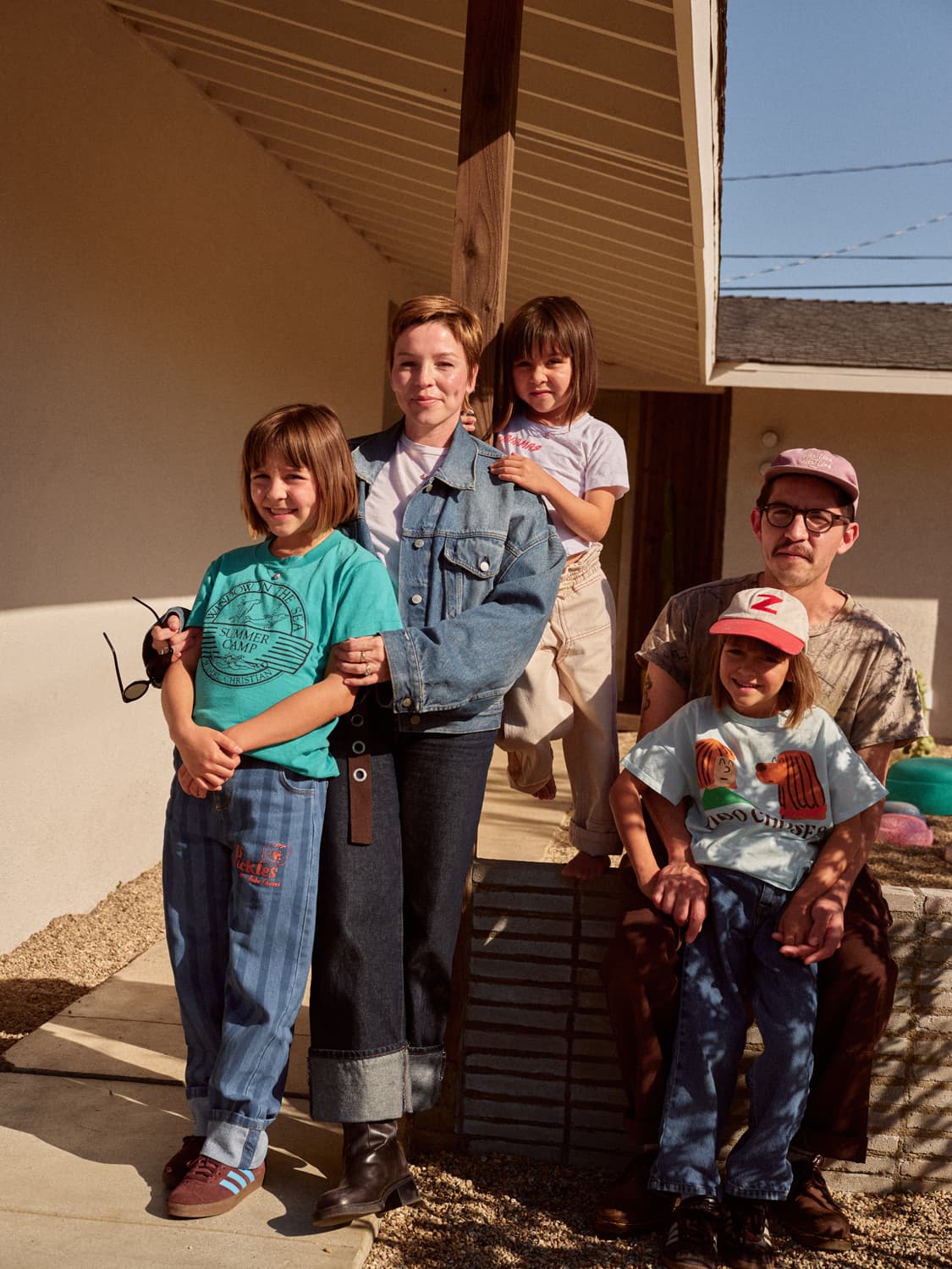 Family of five posing together outside the front porch of their Costa Mesa home