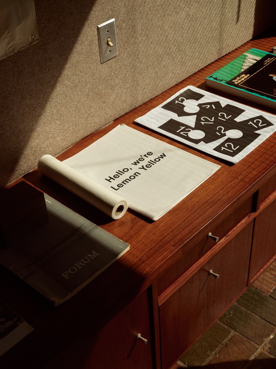 Design publications and Forum magazine on a walnut credenza inside the Strang Design Office